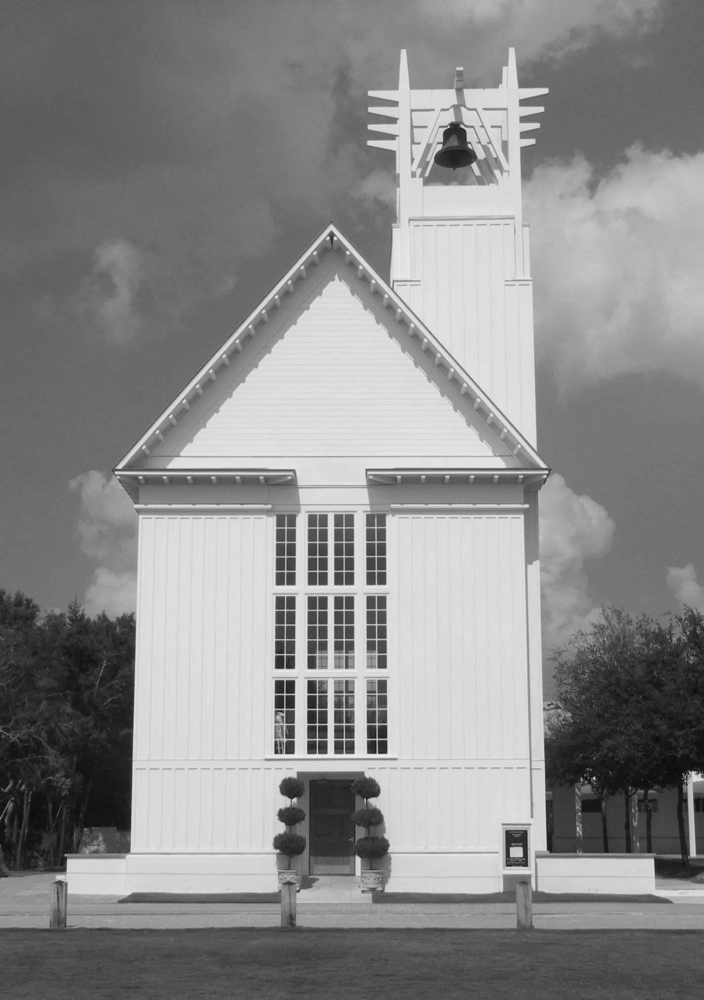 Black-and-white photo of the white wooden Seaside Interfaith Chapel with its open bell tower